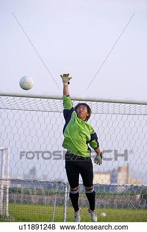 Football goalie diving for ball View Large Photo Image Stock Photo - Football goalie diving for ball. Fotosearch