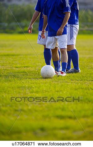Football players on playing field, mid section View Large Photo Image Stock Image - Football players on playing field, mid section. Fotosearch