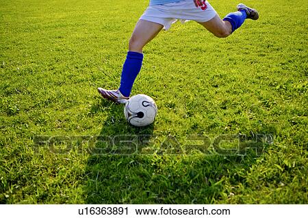 Man kicking soccer ball, mid section View Large Photo Image Stock Image - Man kicking soccer ball, mid section. Fotosearch