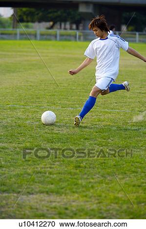 One young man playing soccer ball View Large Photo Image Stock Image - One young man playing soccer ball. Fotosearch