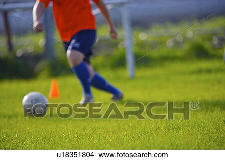 Person kicking soccer ball View Large Photo Image Picture - Person kicking soccer ball. Fotosearch