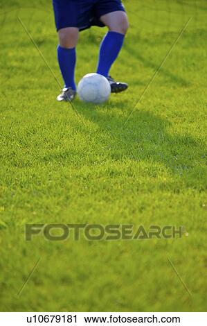 Soccer player kicking ball, mid section View Large Photo Image Stock Image - Soccer player kicking ball, mid section. Fotosearch