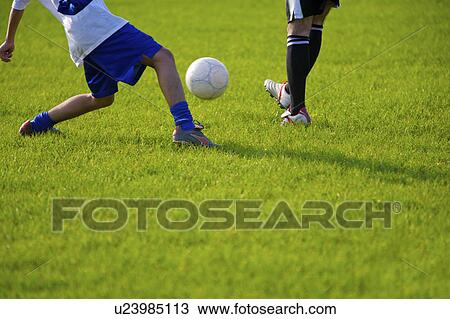 Soccer players kicking ball View Large Photo Image Stock Image - Soccer players kicking ball. Fotosearch