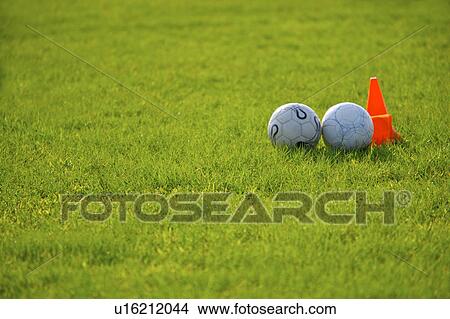 Two soccer balls near red cone View Large Photo Image Picture - Two soccer balls near red cone. Fotosearch