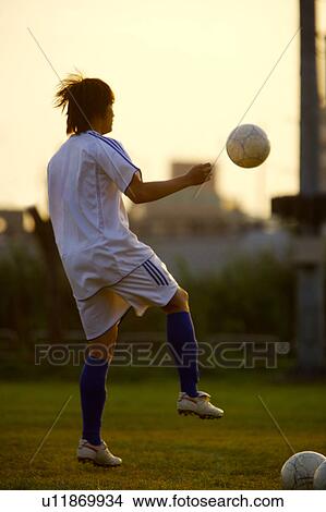 Young man playing soccer View Large Photo Image Picture - Young man playing soccer. Fotosearch