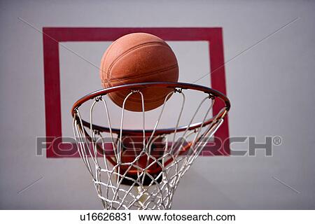A basketball goes through the hoop View Large Photo Image Stock Image - A basketball goes through the hoop. Fotosearch