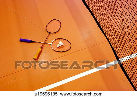 Stock Photography - Badminton rackets and shuttlecock on badminton court. Fotosearch