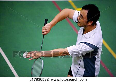 Man prepares to serve during a game of badminton View Large Photo Image Stock Image - Man prepares to serve during a game of badminton. Fotosearch
