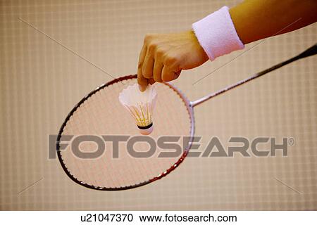 Man prepares to serve during a game of badminton, focus on hand View Large Photo Image Stock Image - Man prepares to serve during a game of badminton, focus on hand. Fotosearch