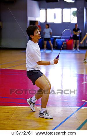 Mature man poised to hit shuttlecock with badminton racket View Large Photo Image Stock Image - Mature man poised to hit shuttlecock with badminton racket. Fotosearch