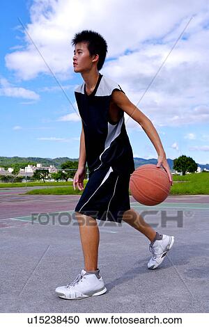 Teenage boy dribbling basketball View Large Photo Image Stock Image - Teenage boy dribbling basketball. Fotosearch