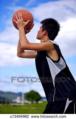 Teenage boy preparing to throw basketball View Large Photo Image Stock Image - Teenage boy preparing to throw basketball. Fotosearch