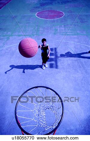 Teenage boy shooting a basketball View Large Photo Image Stock Image - Teenage boy shooting a basketball. Fotosearch