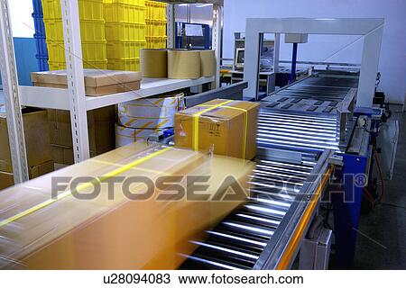 Stock Image - Boxes on conveyor belt. Fotosearch