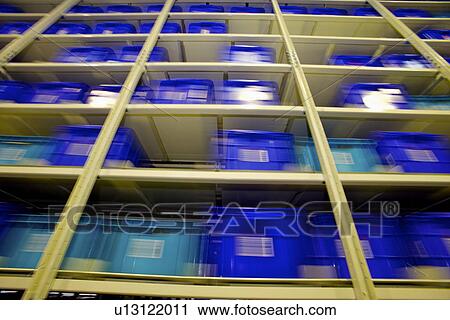 Stock Image - Boxes on shelves in warehouse. Fotosearch