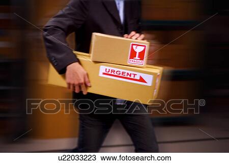 Man with boxes labeled 'fragile, urgent' View Large Photo Image Stock Image - Man with boxes labeled 'fragile, urgent'. Fotosearch