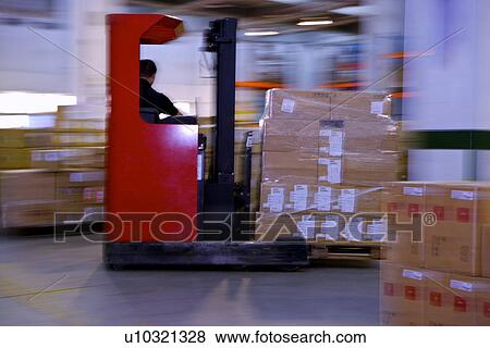 Stock Photo - Man with Forklift Truck in Warehouse. Fotosearch