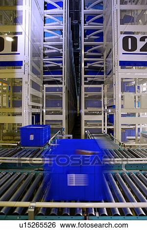 Plastic boxes on conveyor belt in warehouse View Large Photo Image Stock Photograph - Plastic boxes on conveyor belt in warehouse. Fotosearch
