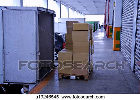 Warehouse exterior view with cardboard boxes and land vehicle View Large Photo Image Stock Photography - Warehouse exterior view with cardboard boxes and land vehicle. Fotosearch