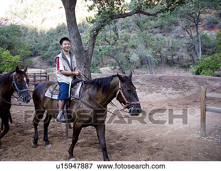 Stock Photo - Boy on horse smiling, Zion National Park, Utah, USA. Fotosearch
