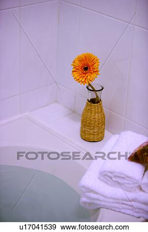 Stock Photo - Bathtub with towel and flower. Fotosearch