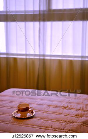 Stock Photo - Cup on bed. Fotosearch