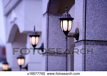 Stock Image - Lamps on wall. Fotosearch