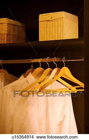 Shirts on hanger in wardrobe View Large Photo Image Picture - Shirts on hanger in wardrobe. Fotosearch