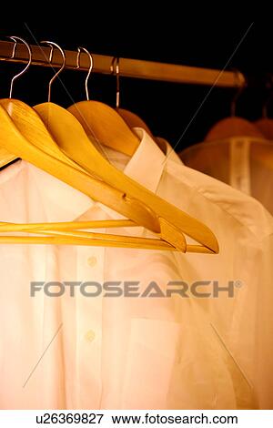 Shirts on hanger in wardrobe View Large Photo Image Stock Photo - Shirts on hanger in wardrobe. Fotosearch
