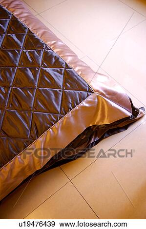 Stock Photo - Bed on tiled floor. Fotosearch