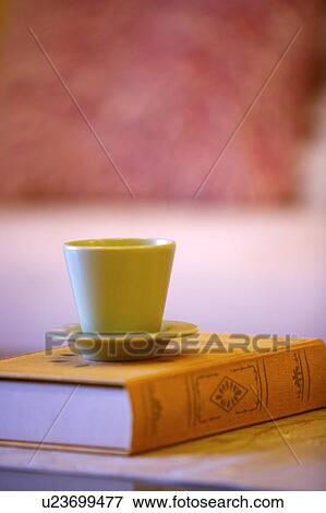 Cup on book View Large Photo Image Stock Photo - Cup on book. Fotosearch