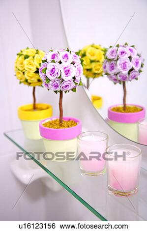 Stock Photograph - Flower pots and candles near mirror. Fotosearch