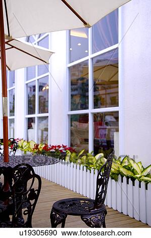 Stock Image - Outdoor table with sunshade. Fotosearch