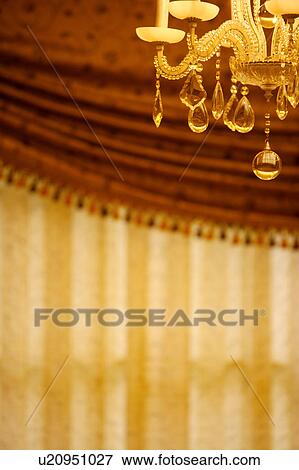 Stock Photo - Part of chandelier hanging on ceiling. Fotosearch