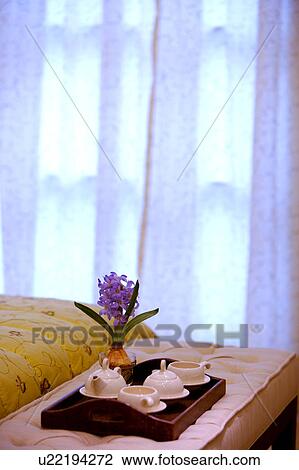 Stock Image - Tea set near bed. Fotosearch