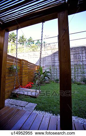 Stock Photography - Wooden swing in garden. Fotosearch