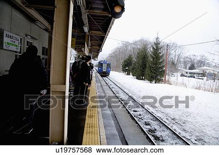 Stock Photo - Japan, Hokkaido, Passengers at Railroad Station. Fotosearch