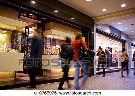 Stock Photograph - People shopping in shopping mall. Fotosearch