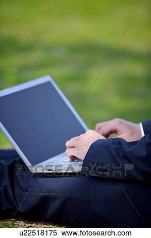 Young businessman using laptop View Large Photo Image Stock Photography - Young businessman using laptop. Fotosearch