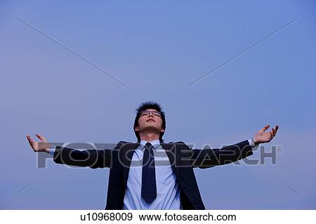 Stock Photo - Young businessman with arms outstretched. Fotosearch