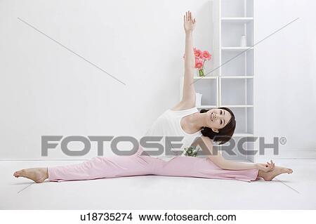 Picture - Young woman doing yoga of the splits. Fotosearch