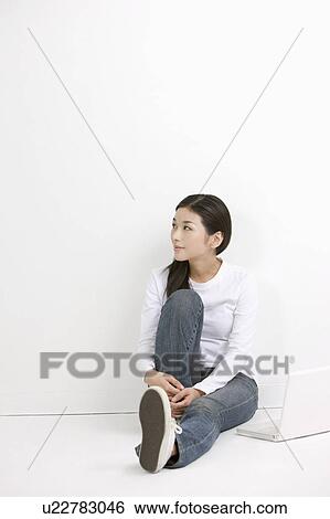 Young woman sitting with laptop View Large Photo Image Stock Photograph - Young woman sitting with laptop. Fotosearch
