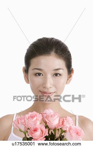"Young woman smiling with flowers, portrait" View Large Photo Image Stock Image - "Young woman smiling with flowers, portrait". Fotosearch