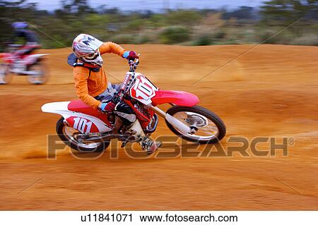 Young man motocross over field. View Large Photo Image Stock Image - Young man motocross over field.. Fotosearch