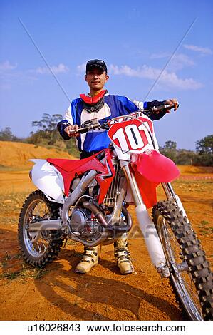Young man motocross over field. View Large Photo Image Stock Image - Young man motocross over field.. Fotosearch