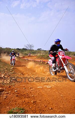 Stock Image - Young man motocross over field.. Fotosearch