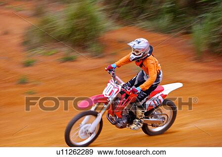 Young man motocross over field. View Large Photo Image Stock Photo - Young man motocross over field.. Fotosearch