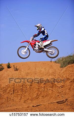Young man motocross over field. View Large Photo Image Stock Photo - Young man motocross over field.. Fotosearch