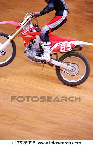 Stock Photo - Young man motocross over field.. Fotosearch