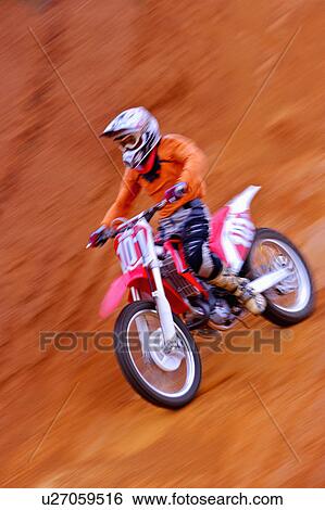 Young man motocross over field. View Large Photo Image Stock Photograph - Young man motocross over field.. Fotosearch